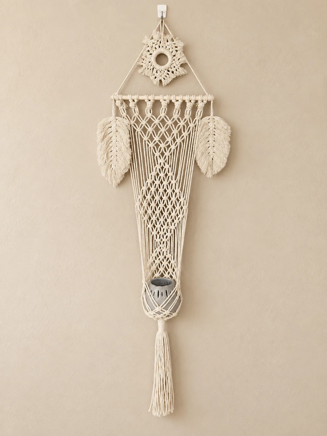 Cream macramé wall pocket with feather details